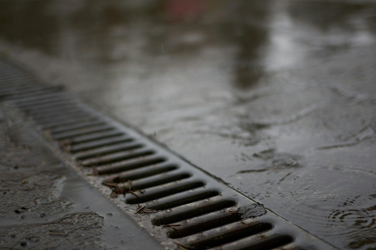 Metal floor drain on a wet concrete surface