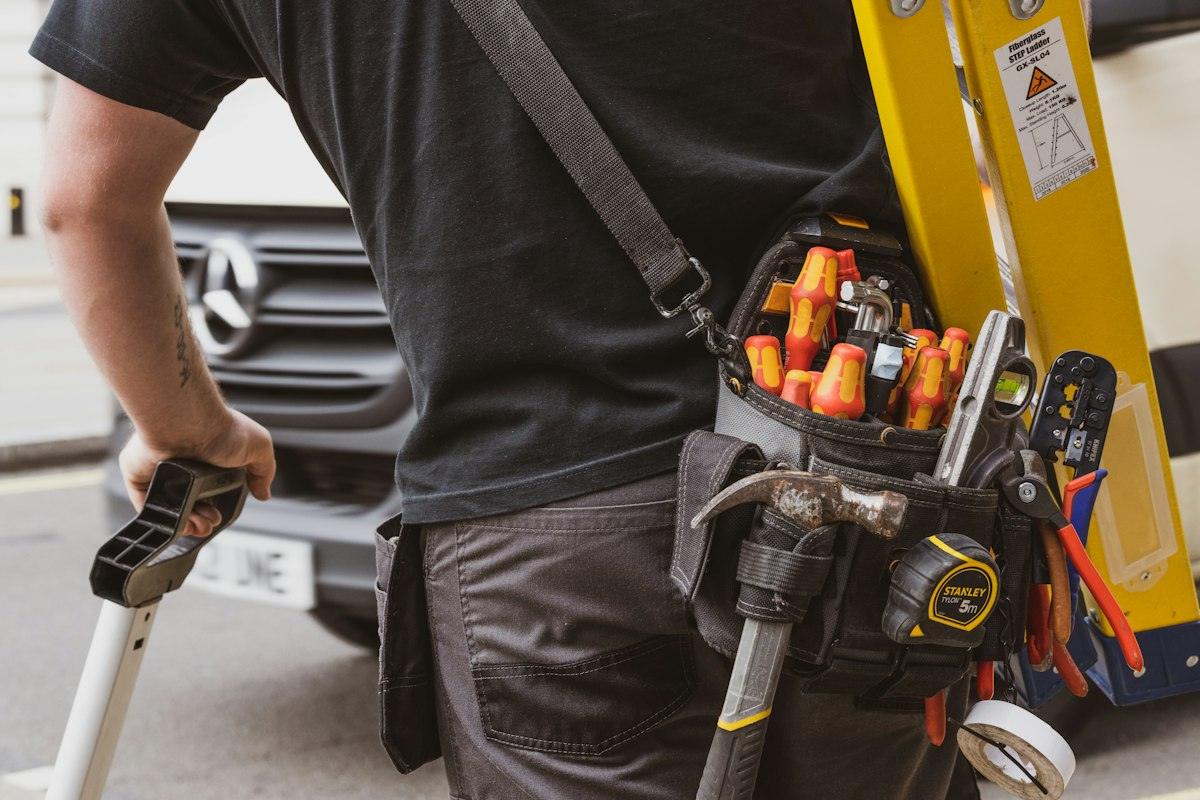 Plumbing technician holding a power tool